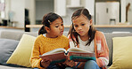 Reading book, friends and girls in home, relax and education for language development. Apartment, fantasy novel and kids on couch, storytelling and learning for growth, knowledge and imagination