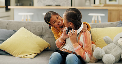 Buy stock photo Happy, sisters and children with tablet on sofa for bonding, playful relationship and entertainment in home. Family, siblings and girls with tech, headphones and online videos to relax in living room