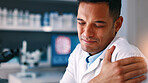 Man, scientist and shoulder pain with injury at lab for medical research career, stress or muscle strain. Person, sore joint and fibromyalgia with pharma study for healthcare with vaccine development