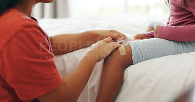 Buy stock photo Mother, child and bandage in home with knee injury, first aid assistance and wound from accident. Woman, daughter and help in bedroom with plaster, bruise and healing support for hurt leg in house.