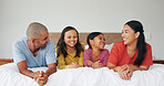 Happy family, parents and kids relax on bed, bonding together and laughing with care in morning. Children, mother and father in bedroom at home with funny joke, connection and love in apartment