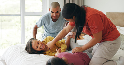 Buy stock photo Tickle, parents and children relax on bed, bonding together and laugh with care in morning at house. Kids, mother and father play in bedroom at home with funny game, family connection and love