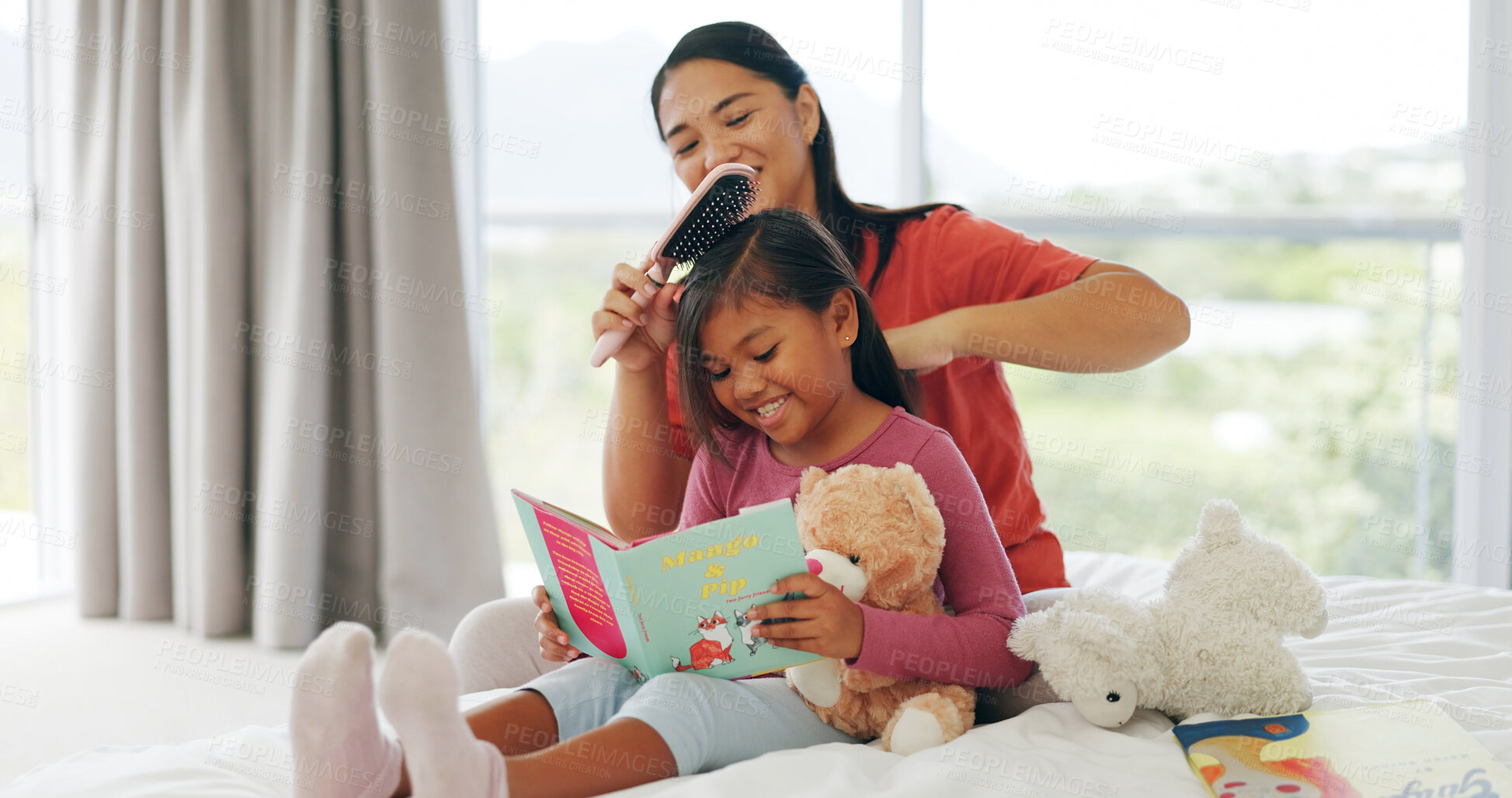 Buy stock photo Hairbrush, mother and reading with daughter in bedroom of home for education or grooming. Book, family time and haircare of girl child with single parent woman on bed for bonding, learning or study