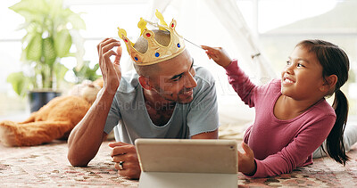 Buy stock photo Costume, smile and tablet of girl with dad on living room floor for family or fantasy story. App, crown and wand of child with single parent man in apartment for development, learning or streaming