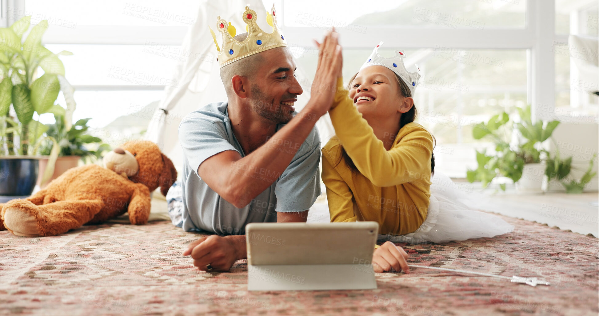 Buy stock photo Education, high five and tablet of daughter with dad on living room floor for family or fantasy story. Crown, success and wand of girl child with happy parent in home for learning or streaming