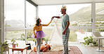 Crown, father and child with dancing in home for fun bonding, fantasy dress up and support. Holding hands, happy dad and kid with costume for pretend play, royal performance and creative imagination