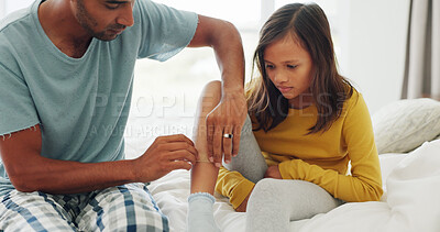 Buy stock photo Father, daughter and bandage in home with leg injury, first aid assistance and wound from accident. Man, girl child and help in bedroom with plaster, bruise or healing support for sore skin in house.