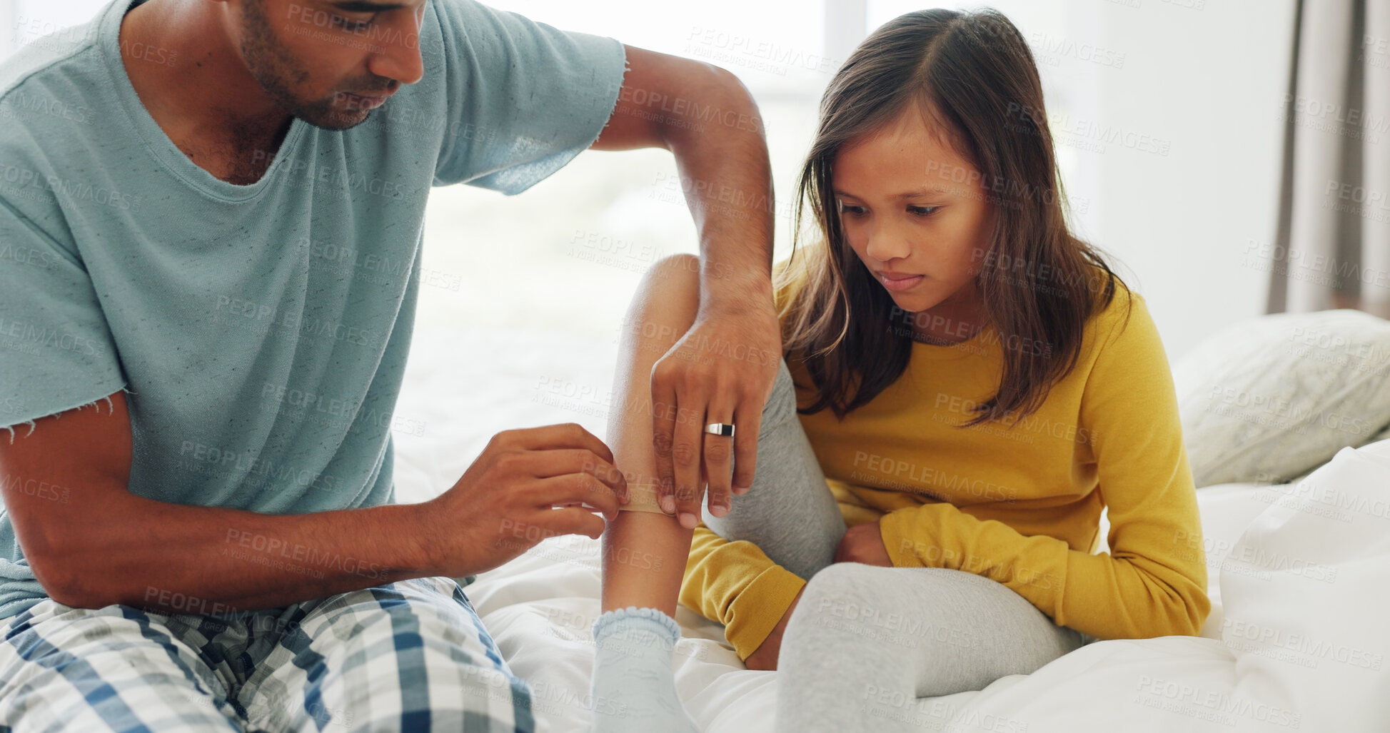 Buy stock photo Father, daughter and bandage in home with leg injury, first aid assistance and wound from accident. Man, girl child and help in bedroom with plaster, bruise or healing support for sore skin in house.