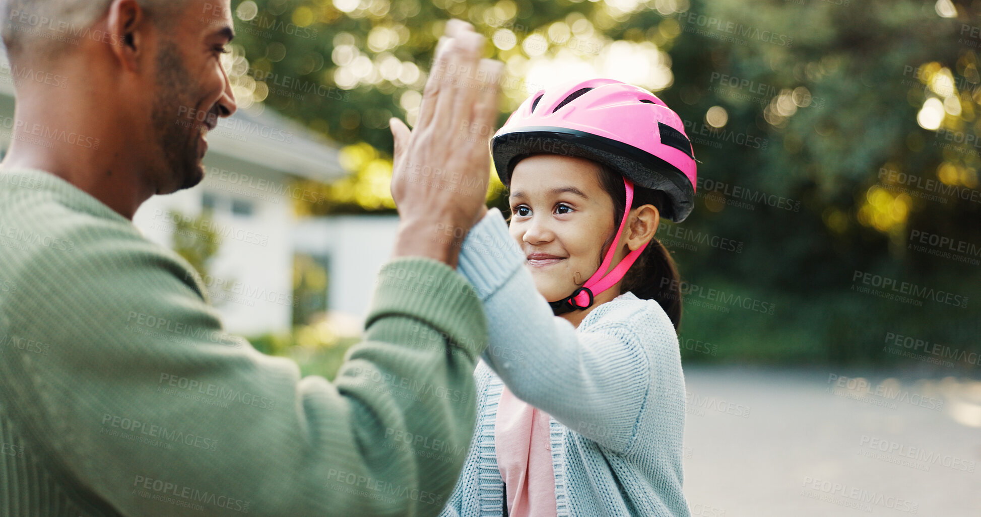Buy stock photo Bike, learning and father with girl, high five for support and child development with smile. Parent, outdoor and dad with daughter, gesture for growth and teaching with celebration for goal or safety