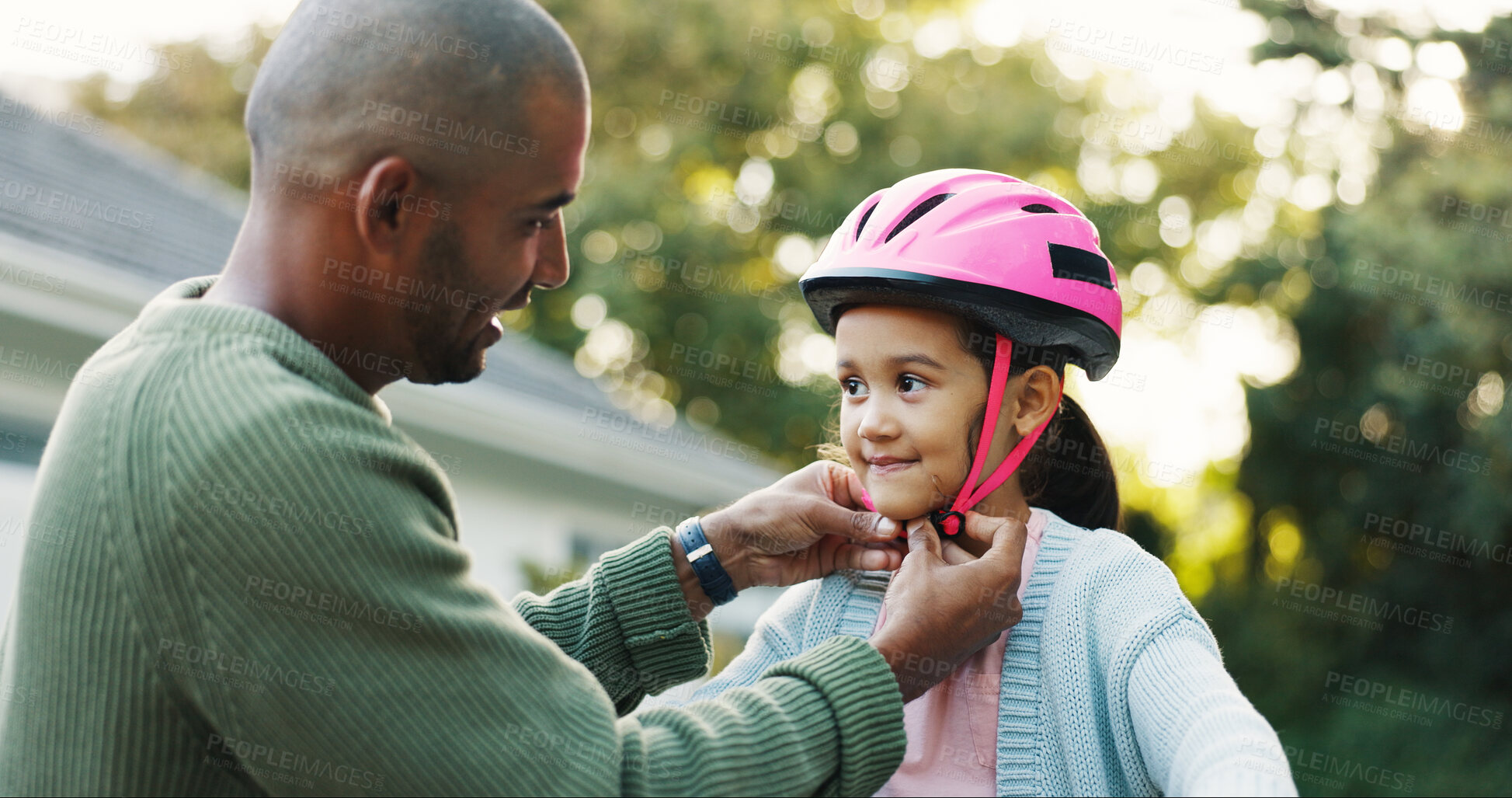Buy stock photo Helmet, protection and father teaching daughter how to ride bicycle outdoor in front of home. Development, safety and smile of girl child with single parent man in driveway for cycling or learning