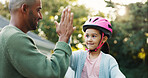 Helmet, learning and father with girl, high five for support and child development with safety. Parent, protection and dad with daughter, gesture for growth and teaching with celebration for goals