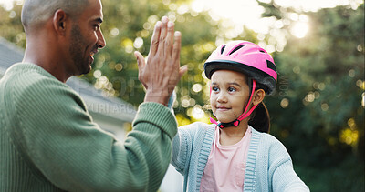 Buy stock photo Helmet, learning and father with girl, high five for support and child development with safety. Parent, protection and dad with daughter, gesture for growth and teaching with celebration for goals