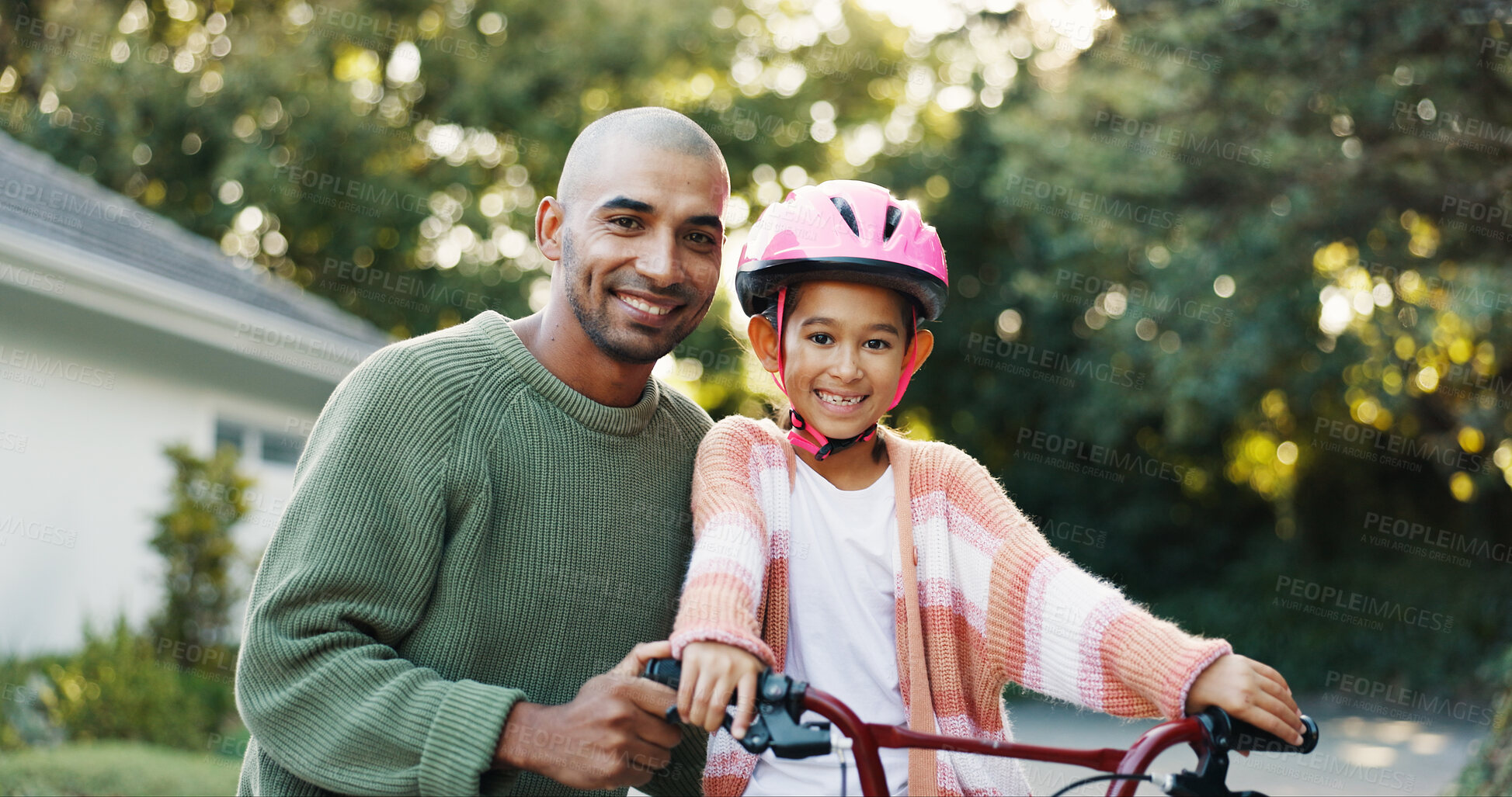 Buy stock photo Bicycle, portrait and father teaching daughter how to ride outdoor in front of home for safety. Development, helmet and smile of girl child with single parent man in driveway for cycling or learning