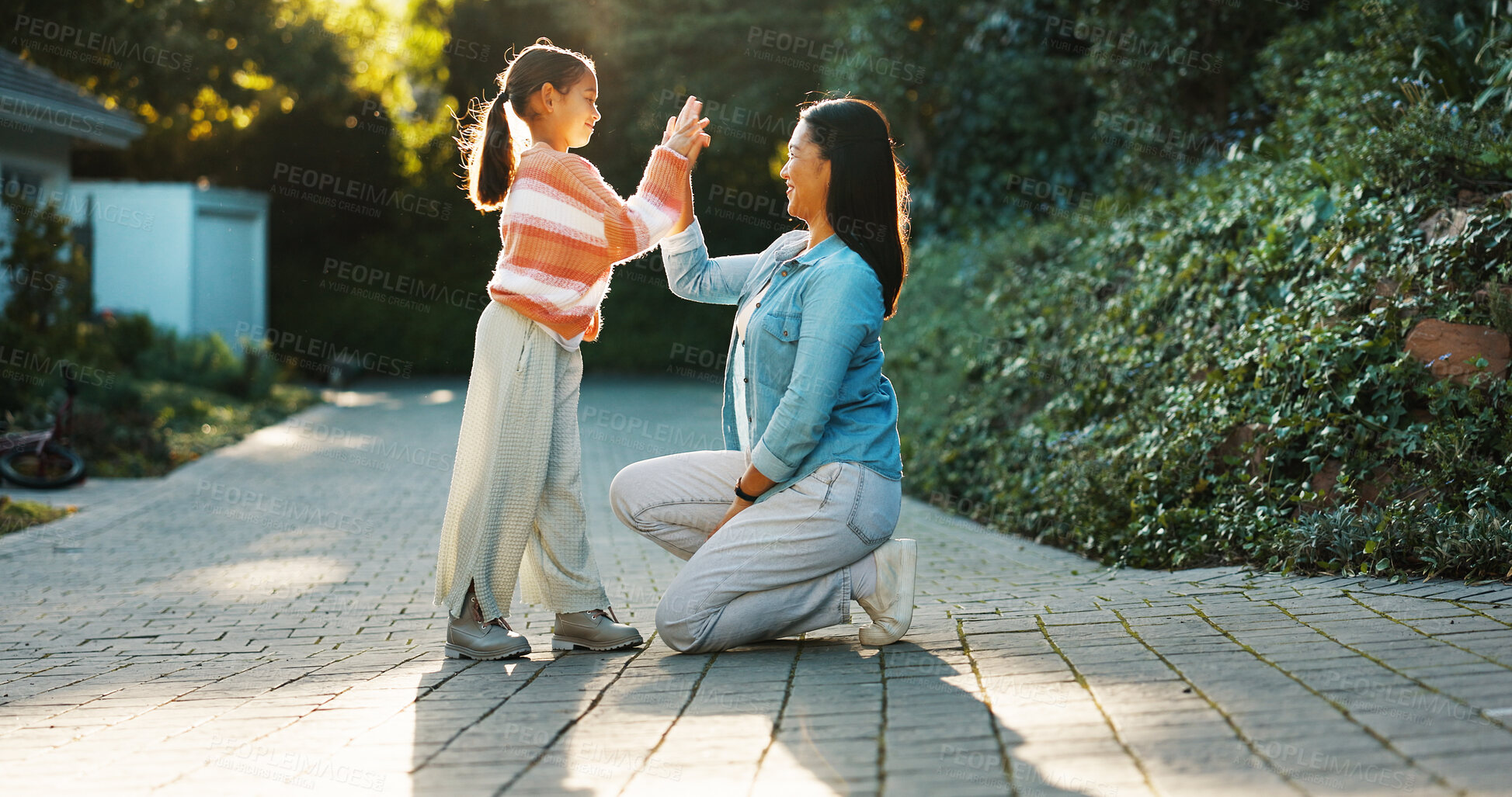 Buy stock photo Mother, child and high five in backyard with smile, bonding together and motivation for development. Happy, woman and daughter outdoor by house with support, connection and encouragement for growth.