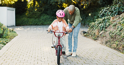 Buy stock photo Bicycle, push and father teaching daughter how to balance or ride outdoor in front of home. Help, protection and safety of girl child with single parent man in driveway for cycling or learning