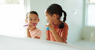 Buy stock photo Sisters, girls and brushing teeth by mirror in bathroom, oral hygiene and morning routine for bonding. Reflection, grooming and happy children with toothbrush for dental care, cleaning mouth and home