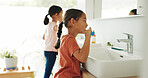 Sisters, girl or brushing teeth by sink in bathroom, oral hygiene or morning routine for wellness. Healthy habit, grooming together or children with toothbrush for dental care, cleaning mouth or home