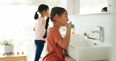 Buy stock photo Sisters, girl or brushing teeth by sink in bathroom, oral hygiene or morning routine for wellness. Healthy habit, grooming together or children with toothbrush for dental care, cleaning mouth or home