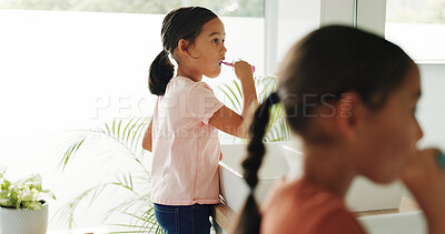 Buy stock photo Sisters, girl and brushing teeth by mirror in bathroom, oral hygiene and morning routine for grooming. Wellness practice, home or children with toothbrush for dental care, clean mouth or fresh breath