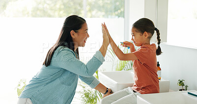 Buy stock photo Toothbrush, high five and girl in bathroom, mother and learning with support, smile and routine. Gesture, mama and daughter in home, happiness and cleaning mouth for hygiene, kid and remove bacteria