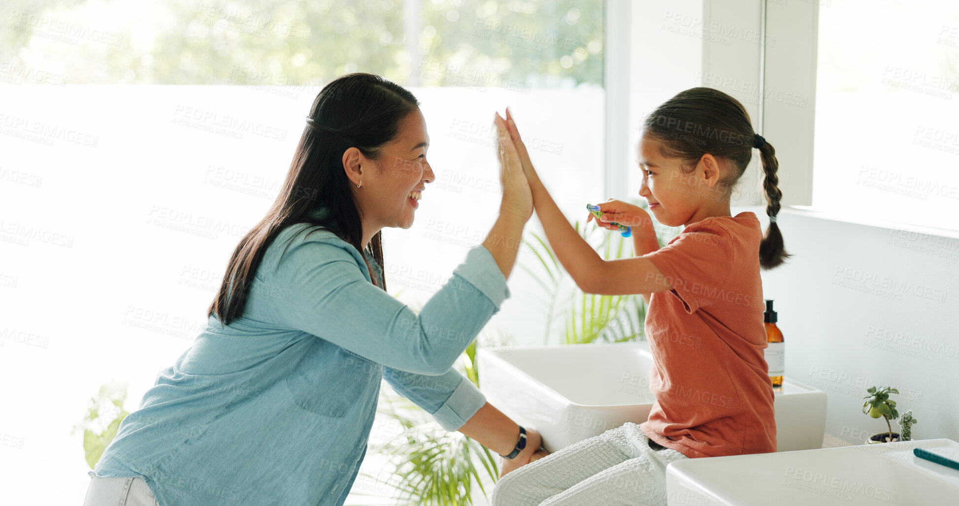 Buy stock photo Toothbrush, high five and girl in bathroom, mother and learning with support, smile and routine. Gesture, mama and daughter in home, happiness and cleaning mouth for hygiene, kid and remove bacteria