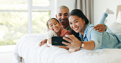 Buy stock photo Happy family, parents and girl with selfie on bed, social media update and bonding for weekend break. Profile picture, toy and people with child for photography, support and smile together in home