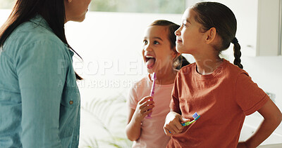 Buy stock photo Kids, mom and check for dental health in bathroom, gum wellness and fresh breath with parent. Girls, toothbrush and mouth inspection with mother in home, clean teeth and learning oral hygiene