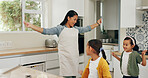 Dancing, mother and children with smile in kitchen, holiday celebration and family bonding on weekend. Connection, woman and girls with happiness in home for care, music and groove for fun together