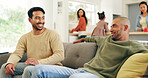 Conversation, relax and men on sofa in home for bonding, friendship or support on weekend. Happy, talking and male people in living room for discussion on sports, family or fitness in apartment.