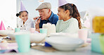 Grandfather, children and horn for birthday celebration, bonding together and care with generations. Grandparent, happy girls and blower at party with cake, special day and young kids in family home