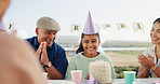 Birthday cake, family and girl in home, smile and bonding together for celebration. People, hat and parents with daughter in lounge, cheering and singing with fun, excited and love with care or party