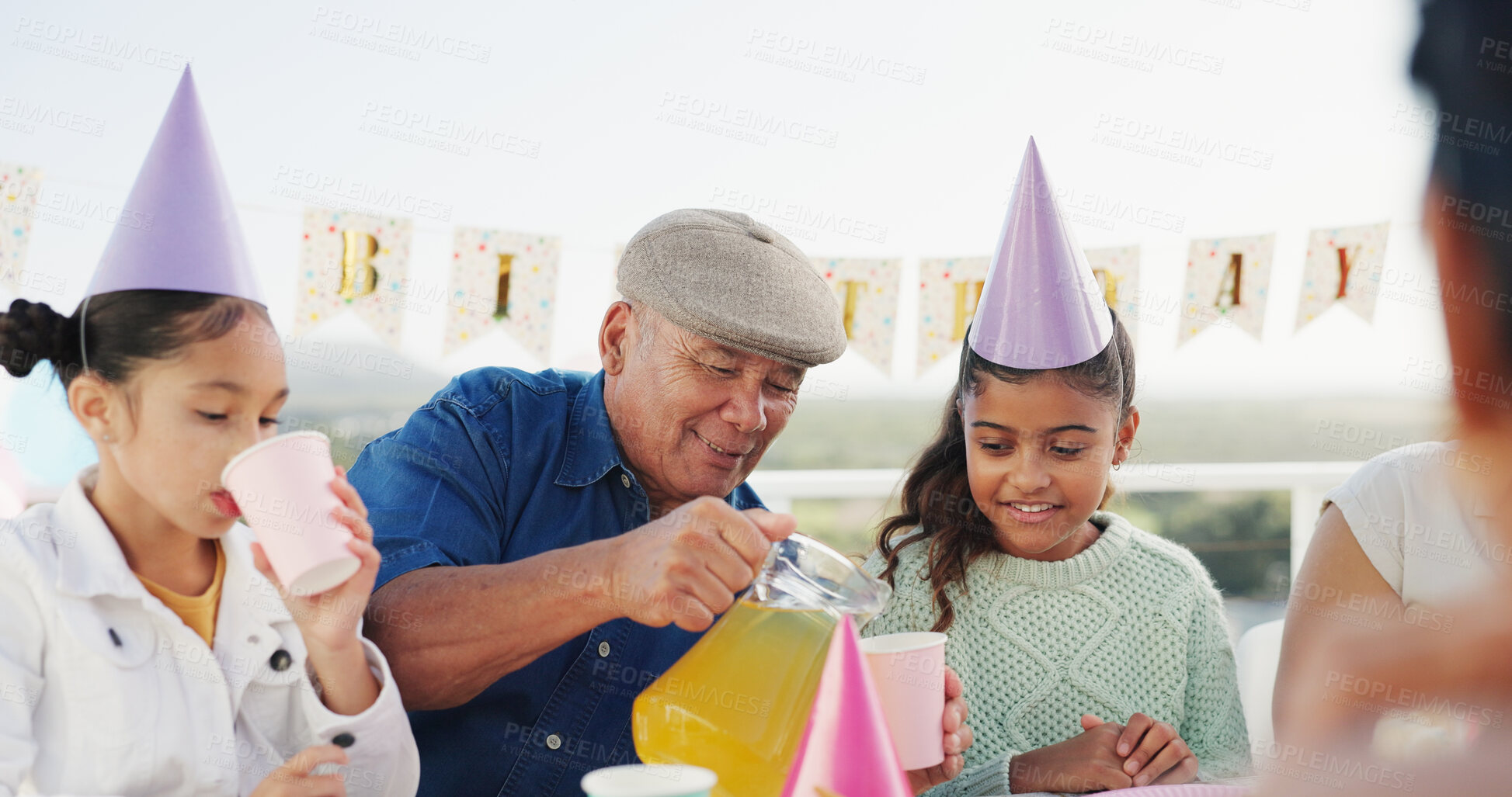Buy stock photo Grandfather, children and juice for birthday at patio, bonding together and care with generations. Grandparent, girls and pour drink at party on special day, celebration and happy kids in family home