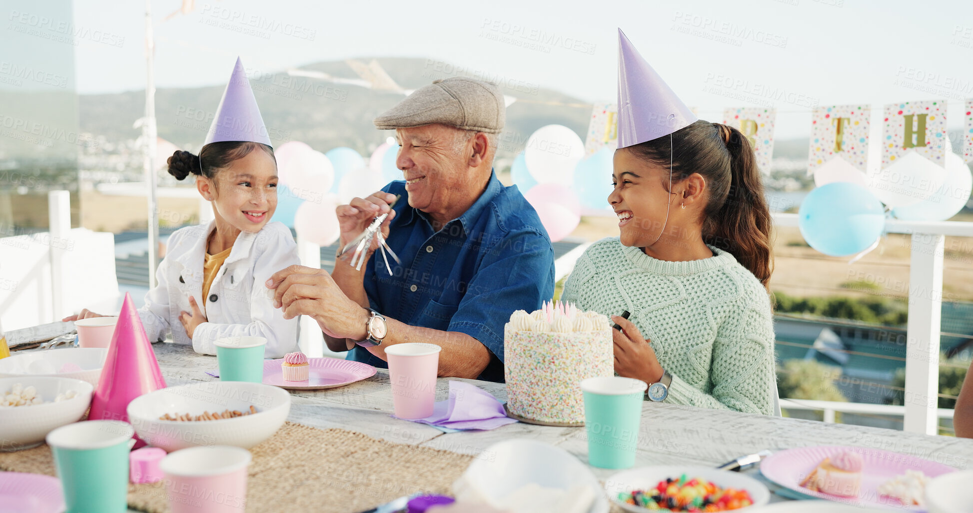 Buy stock photo Grandfather, kids and horn for birthday celebration, bonding together and laughing at patio. Grandparent, happy girls and blower at party with cake, special day and funny children at family home