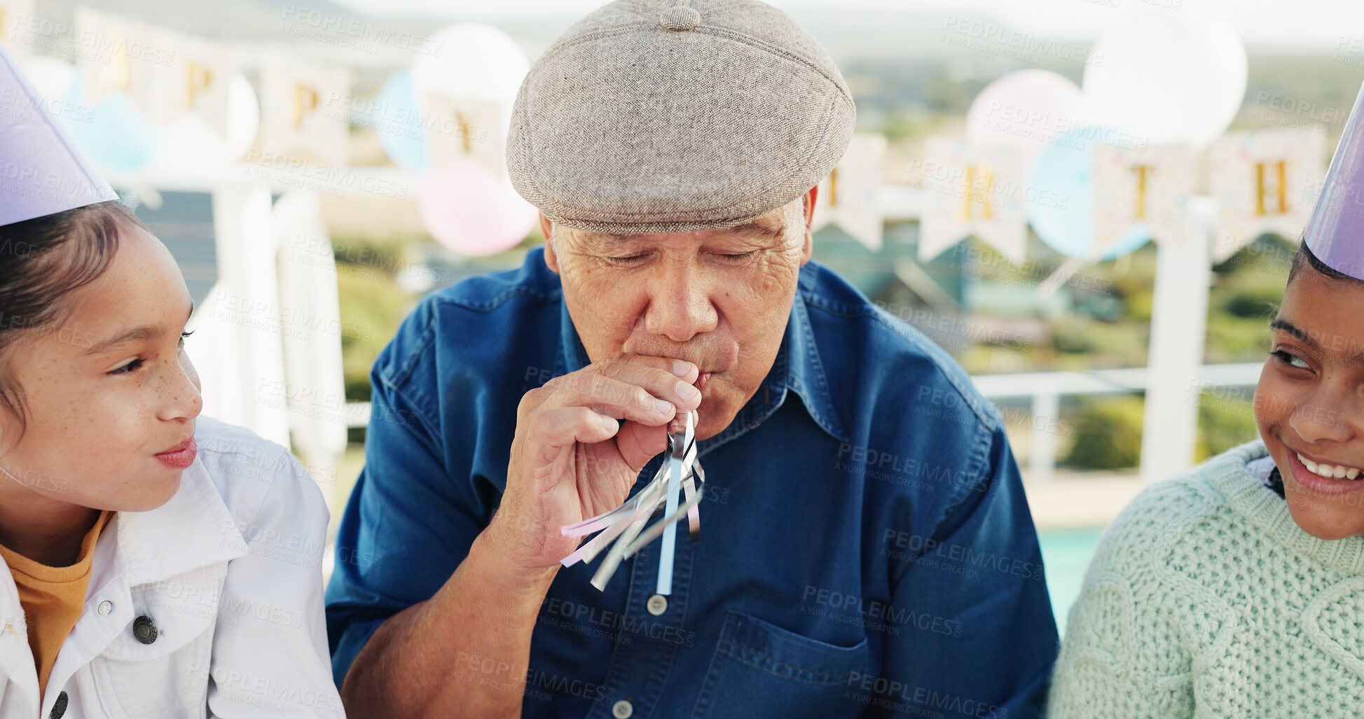 Buy stock photo Grandfather, children and blower for birthday celebration, bonding together or generations at patio. Grandparent, happy girls and horn at party for special day, kids and support at family home