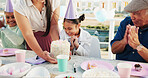 Happy child, family and applause with birthday cake or party hat for outdoor celebration together. Excited, group or clapping with smile, dessert or milestone for year, wishing or social gathering
