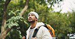 Thinking, travel and hiking with man in nature for eco tourism, adventure and national park. Sustainability vacation, backpacking and trekking with person outdoor for wellness, vision and explore
