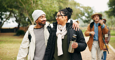 Buy stock photo Couple, hiking and happy with embrace at park with group, outdoor and bonding on vacation in winter. People, walk and trekking with smile, love and connection with care on holiday for nature tourism