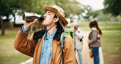 Buy stock photo Hiking, drinking water and man in forest, fitness and countryside for trekking adventure. Group, hiker and person in woods, hydration and health benefits with rest, thirsty and nutrition with bottle