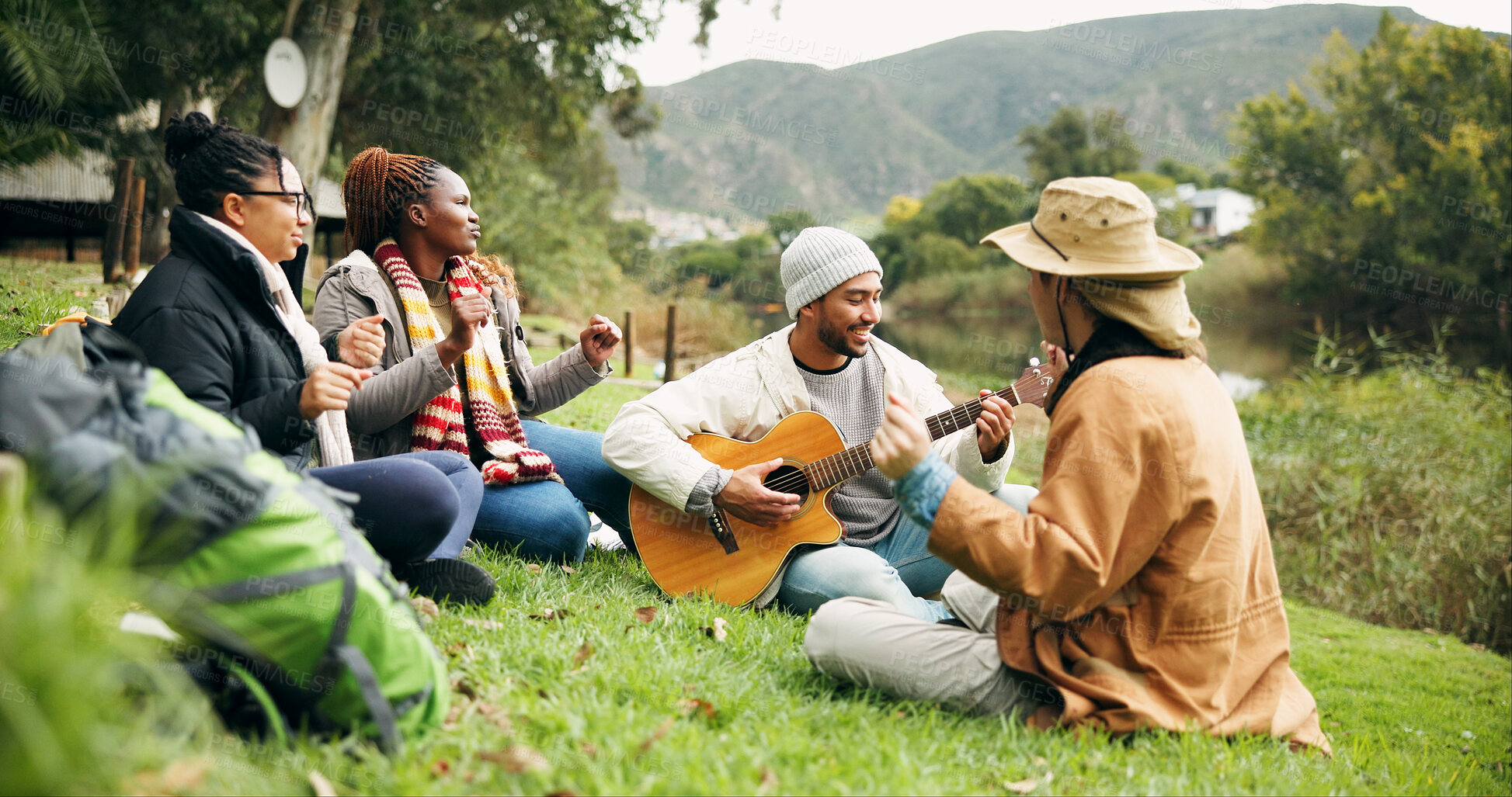 Buy stock photo Camping, friends and people with guitar, outdoor and bonding together for reunion, holiday and singing. Happy, musician or group in woods, vacation and string instrument for song, relax and listening