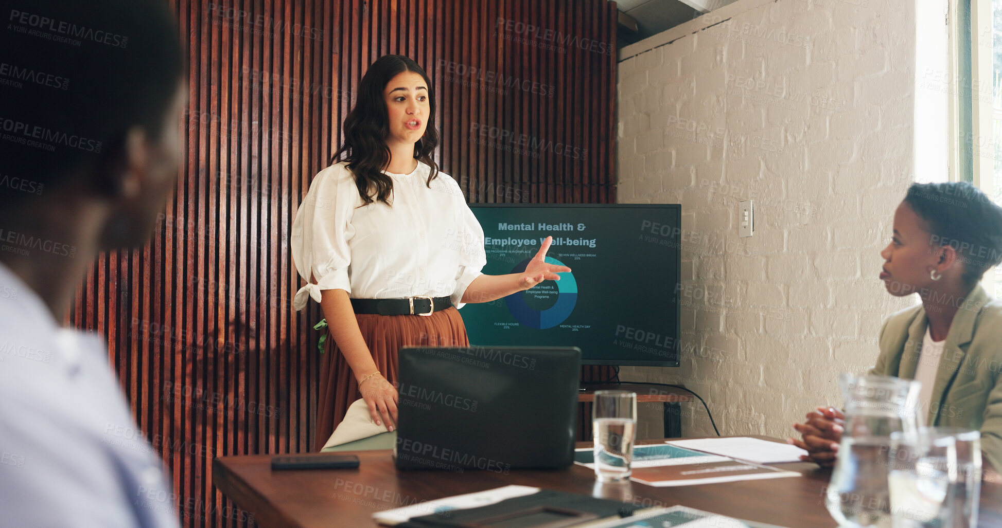 Buy stock photo Woman, presentation and mental health at office meeting with team, monitor and graphs at hr company. Person, speaker and screen with discussion, feedback or review with charts for employee wellness