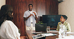 Man, presentation and content marketing at office meeting with monitor, explain or graphs at media company. People, speaker and screen with team, feedback or review with charts at creative agency