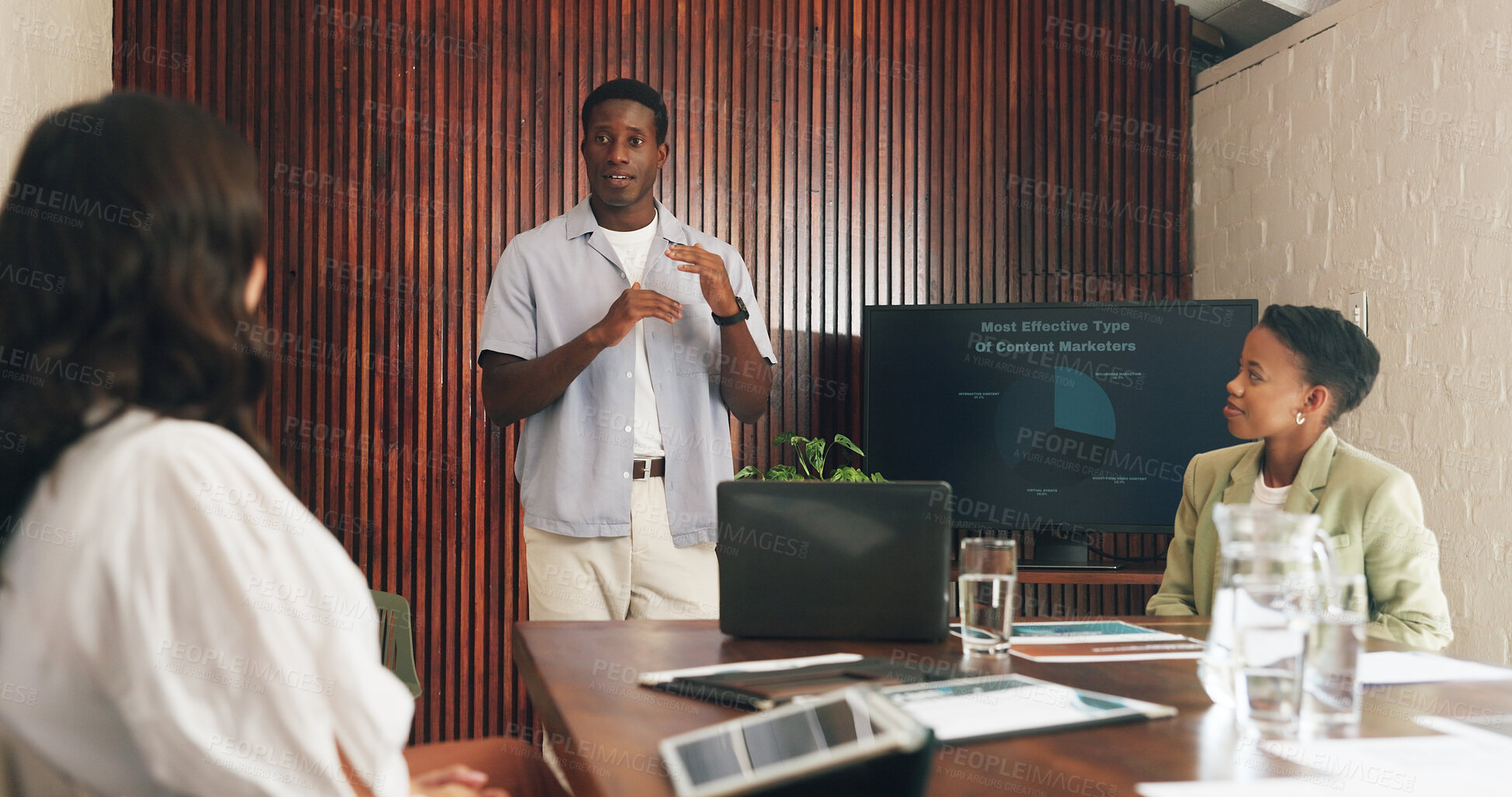 Buy stock photo Man, presentation and content marketing at office meeting with monitor, explain or graphs at media company. People, speaker and screen with team, feedback or review with charts at creative agency