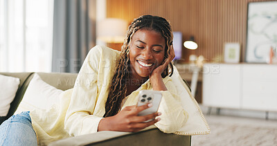 Buy stock photo Black woman, happy and phone with texting on sofa with contact, web chat or online dating in home. African person, smartphone and smile on couch with notification, meme or funny post on social media