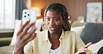 Black woman, phone and chat with video call in home, discussion and funny story in living room. African person, smartphone and happy with mobile app, talk or virtual contact on social media at house