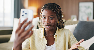 Buy stock photo Black woman, phone and chat with video call in home, discussion and funny story in living room. African person, smartphone and happy with mobile app, talk or virtual contact on social media at house