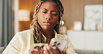 Confused, reading and phone with black woman on sofa in home for communication, mistake and scam. Contact, online glitch and phishing link with person and mobile in living room of apartment for app