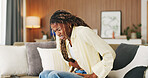Stress, pain and woman with stomach ache on sofa for menstruation, constipation or PMS. Endometriosis cramps, black girl or belly indigestion in home from ovulation cycle, IBS or abdominal discomfort