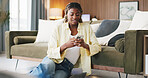 Black woman, phone and texting on floor in home with smile, web chat or online dating in lounge. African person, smartphone and happy for notification, mobile or relax with social media at apartment