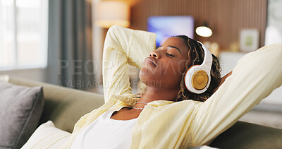 Buy stock photo Black woman, headphones and relax with rest on sofa, eyes closed and break for streaming service in home. African person, chill and listen to music with audio, sound or subscription on couch at house