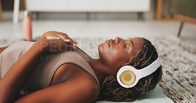 Buy stock photo Headphones, woman and relax on floor for yoga, wellness or self affirmation audio for mental health. Girl, music or subscription in home for positive podcast, streaming sound or breathe in lounge